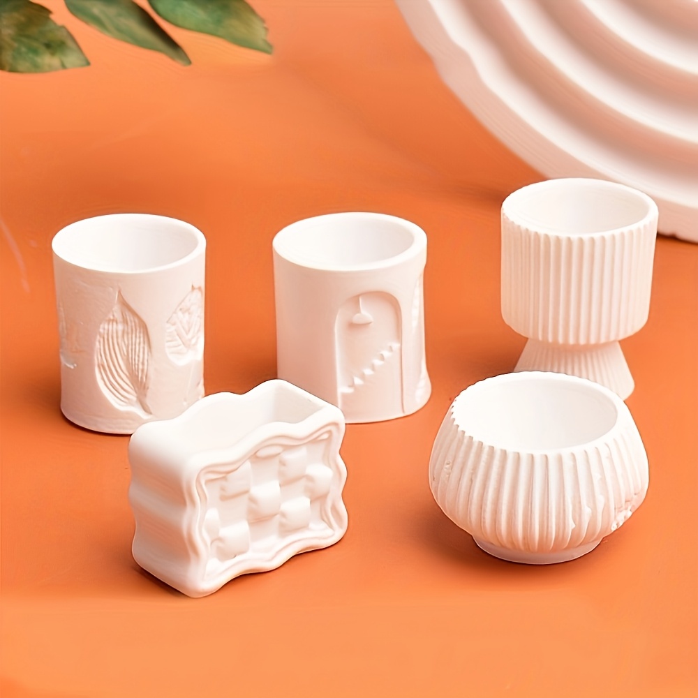 Set of white ceramic containers on an orange background